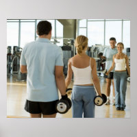 Man and woman lifting hand weights in front of a