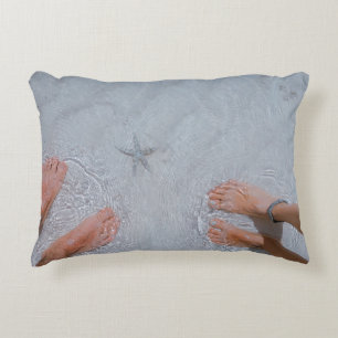 Man and woman on seashore nearby starfish decorative cushion
