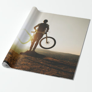 Man carrying bike wrapping paper