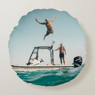 Man diving on pool round cushion