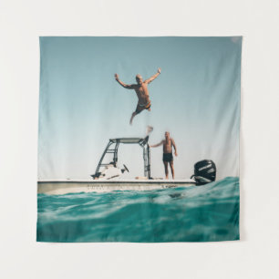 Man diving on pool tapestry