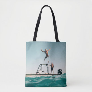 Man diving on pool tote bag