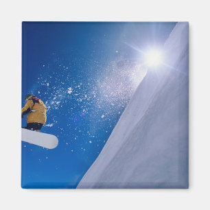 Man flying through the air on a snowboard with magnet