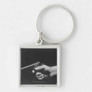 Man Holding Gun Key Ring