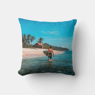 Man holding surf board in body of water cushion