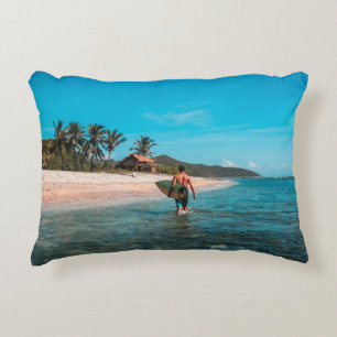 Man holding surf board in body of water decorative cushion