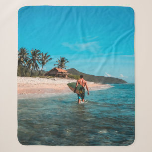 Man holding surf board in body of water sherpa blanket