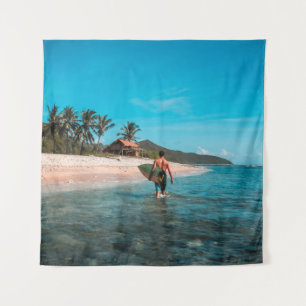 Man holding surf board in body of water tapestry