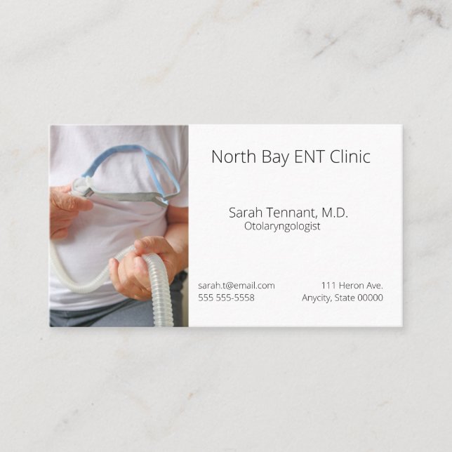 Man holds sleep apnoea device business card (Front)