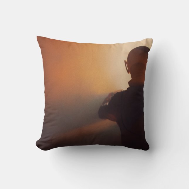 MAN IN BLACK JACKET WEARING BLACK CAP CUSHION (Front)