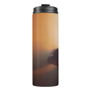 MAN IN BLACK JACKET WEARING BLACK CAP THERMAL TUMBLER