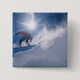 Man jumping off a large cornince on a snowboard 15 cm square badge