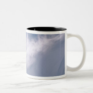 Man jumping off a large cornince on a snowboard Two-Tone coffee mug