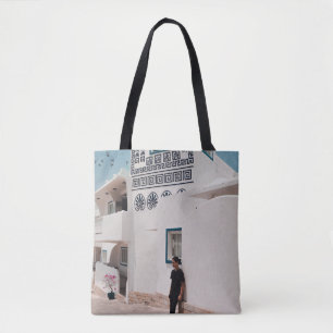 Man lean on concrete house tote bag