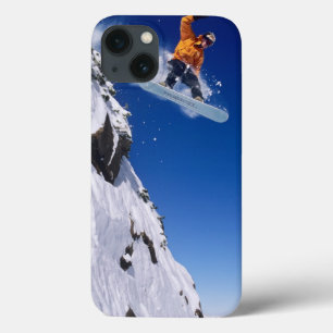 Man on a snowboard jumping off a cornice iPhone 13 case