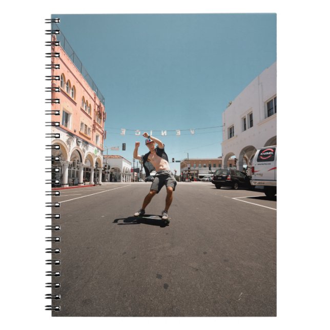 Man playing skateboard notebook (Front)