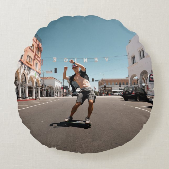 Man playing skateboard round cushion (Front)