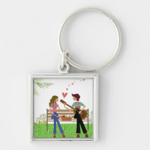 Man playing the guitar with a woman beside her key ring