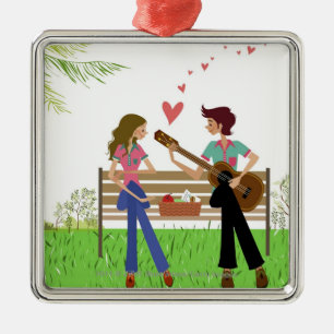 Man playing the guitar with a woman beside her metal ornament