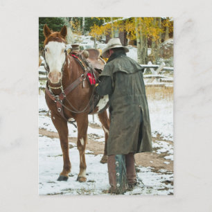 Man putting saddle on horse postcard
