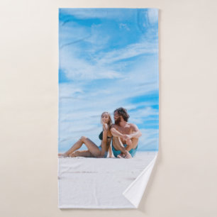 Man sitting beside of woman in black bikini top bath towel