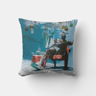 Man sitting on chair underwater with floating bott cushion