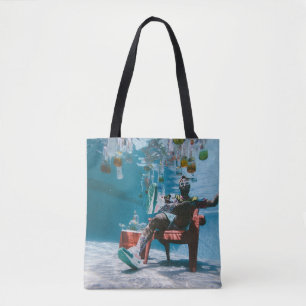 Man sitting on chair underwater with floating bott tote bag