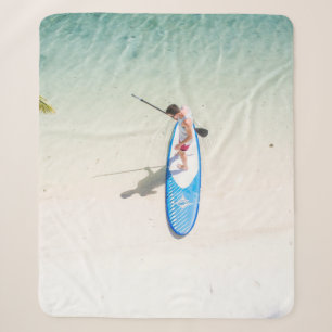 Man surfing on beach sherpa blanket