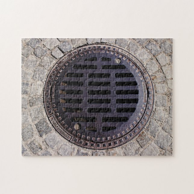 Manhole cover and cobblestone road jigsaw puzzle (Horizontal)