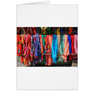 Many colourful scarves hanging at market
