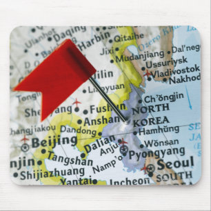 Map pin placed on North Korea on map, close-up Mouse Pad