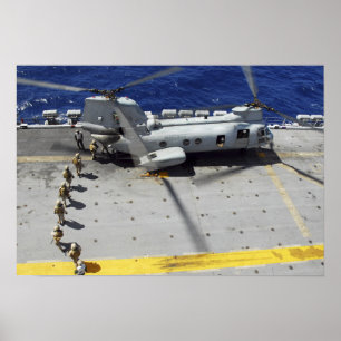 Marines board a CH-46E Sea Knight helicopter Poster