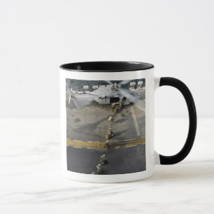 Marines prepare to board an MH-60S Mug