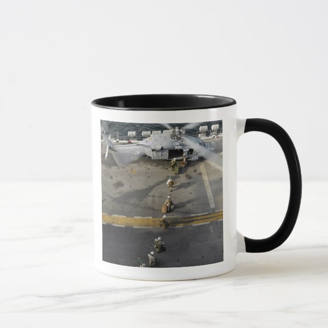 Marines prepare to board an MH-60S Mug (Right)