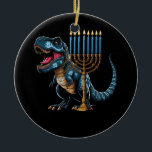 Menorasaurus Rex Trex Dinosaur Hanukkah Menorah Je Ceramic Ornament<br><div class="desc">Fun cute dino who love history and dinosaurs! Makes a great tee for anyone who loves dinosaurs, t rex, stegosaurus, triceratops, brontosaurus, tyrannosaurus rex! What a great tee for girls who loves dinosaurs! Dinosaur Dino tee, Dinosaur lover. Hanukkah is a Jewish festival commemorating the rededication of the Second Temple It...</div>