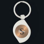 Men's Elegant Monogram Metallic Bronze Gold Key Ring<br><div class="desc">Men's Elegant Monogram Metallic Bronze Gold Keychain makes a cute gift idea for any occasion. Keychain is designed with a faux bronze golden metallic background and monogrammed on center in bold black and personalized with name in white calligraphy script lettering. CLICK PERSONALIZE TEMPLATE OPTION AND ENTER NAME AND MONOGRAM LETTER....</div>