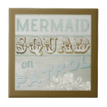 Mermaid Squad on Patrol Ceramic Tile<br><div class="desc">Mermaid Squad on Patrol. This cool piece of art is brought to you by World Art Group, a featured work of June Erica Vess. Set on a rustic wood themed background with subtle imprint patterns, this is a girly classic with bold, inviting gold lettering to really bring the fun to...</div>