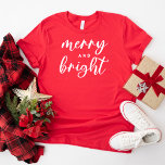 Merry and Bright Modern Red Women's Christmas T-Shirt<br><div class="desc">A festive Christmas graphic tee for women featuring modern lowercase script typography with "Merry and Bright" saying. White text and red tshirt style can both be modified.</div>