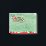 Merry ChrisMUSH Cartoon Mushrooms Post-it Notes<br><div class="desc">Use these cute cartoon mushroom caps (wearing caps) for fun holiday notes.  Text (that can be customised) reads: Merry ChrisMUSH! These have a textured watercolor pattern in green on the paper and a candy cane narrow border on the bottom in red and white.  Spread the cheer!  Happy Holidays!</div>