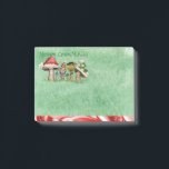Merry ChrisMUSH Cartoon Mushrooms Post-it Notes<br><div class="desc">Use these cute cartoon mushroom caps (wearing caps) for fun holiday notes.  Text (that can be customised) reads: Merry ChrisMUSH! These have a textured watercolor pattern in green on the paper and a candy cane narrow border on the bottom in red and white.  Spread the cheer!  Happy Holidays!</div>