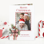 Merry Christmas Candy Cane Bow Photo Holiday Card<br><div class="desc">Fun and festive holiday design featuring a photo template in a candy cane frame with a bouquet of winter holly and greenery tied with a candy cane striped bow. Features Merry Christmas greeting in a unique custom font. Inside features an additional photo template.</div>