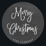 Merry Christmas | Handwritten Script on Chalkboard Classic Round Sticker<br><div class="desc">This simple and trendy holiday sticker says "Merry Christmas" in rustic,  white handwritten script on a black,  chalkboard look background.</div>