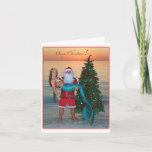 Merry Christmas Mermaid with Santa on the Beach Holiday Card<br><div class="desc">Santa proudly holds a Mermaid on the beach beside a Christmas tree at sunset.</div>