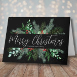 Merry Christmas Modern Elegant Greenery Holiday Card<br><div class="desc">A simple and classic Christmas card look with greenery like evergreen branches, leaves, and more. A black background gives this elegant card a modern look. Subtle hints and pops of colour from the red holly berries give it a little something extra. In centre is 'Merry Christmas' in an elegant script...</div>