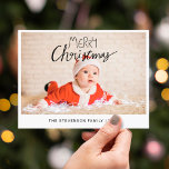 Merry Christmas modern simple photo Holiday Postcard<br><div class="desc">Send this simple and modern Christmas postcard to your family and friends. This Christmas card is personalizable by adding one of your favorite photos, your family name, and year, and features a trendy overlay text that reads "Merry Christmas" in modern handwritten fonts. The back of the card is customizable with...</div>