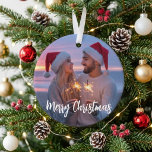 Merry Christmas Romantic Sparkler Couple Photo Ornament<br><div class="desc">This design features a romantic custom photo with elegant Merry Christmas script for a warm and memorable holiday look. The Santa hats, glowing sparklers, and sunset background create a cosy seasonal feel that highlights love and togetherness. It is a lovely choice for couples celebrating a first holiday together, a newlywed...</div>