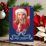 Merry Christmas Simple Modern Coquette Bow Photo Holiday Card<br><div class="desc">Merry Christmas Simple Modern Coquette Bow Photo Folded Holiday Card Christmas Cards features a simple design with your favourite photo with the text overlay "Merry Christmas" in modern calligraphy script typography accented with a trendy white bow on a blue background. Personalised your names or custom text below and your custom...</div>