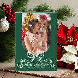 Merry Christmas Simple Modern Coquette Bow Photo Holiday Card<br><div class="desc">Merry Christmas Simple Modern Coquette Bow Photo Folded Holiday Card Christmas Cards features a simple design with your favourite photo with the text overlay "Merry Christmas" in modern calligraphy script typography accented with a trendy white bow on a green background. Personalised your names or custom text below and your custom...</div>