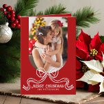 Merry Christmas Simple Modern Coquette Bow Photo Holiday Card<br><div class="desc">Merry Christmas Simple Modern Coquette Bow Photo Folded Holiday Card Christmas Cards features a simple design with your favourite photo with the text overlay "Merry Christmas" in modern calligraphy script typography accented with a trendy white bow on a red background. Personalised your names or custom text below and your custom...</div>
