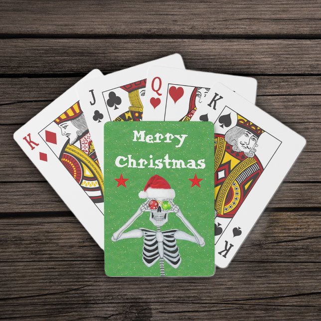 Merry Christmas Skeleton Ornaments Stars Santa Hat Playing Cards (Merry Christmas silly skeleton ornament eyes  red stars on green deck of playing cards.)